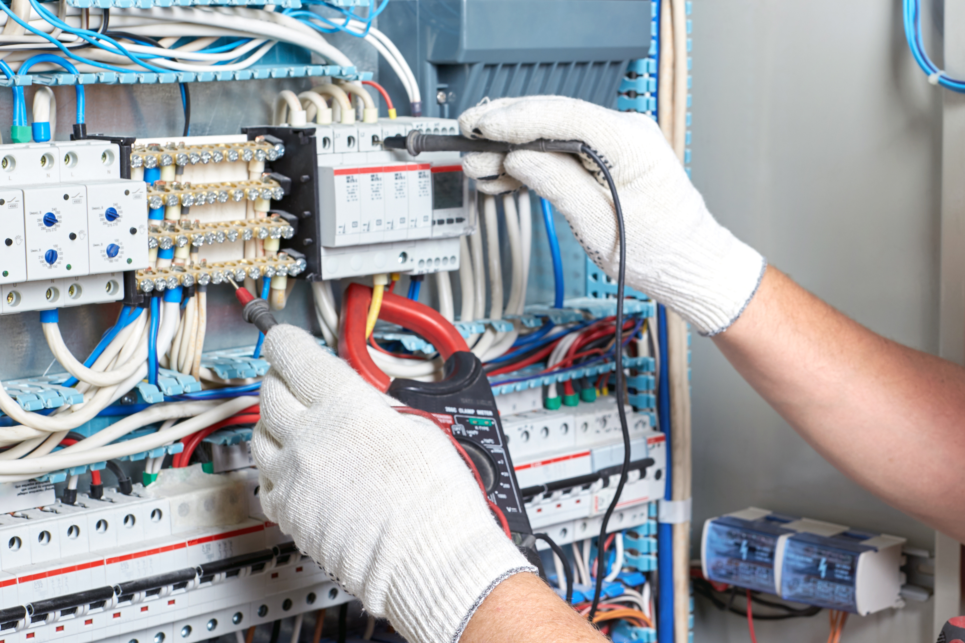 Closeup of an electrician's hand with a diagnostic tool in his hand